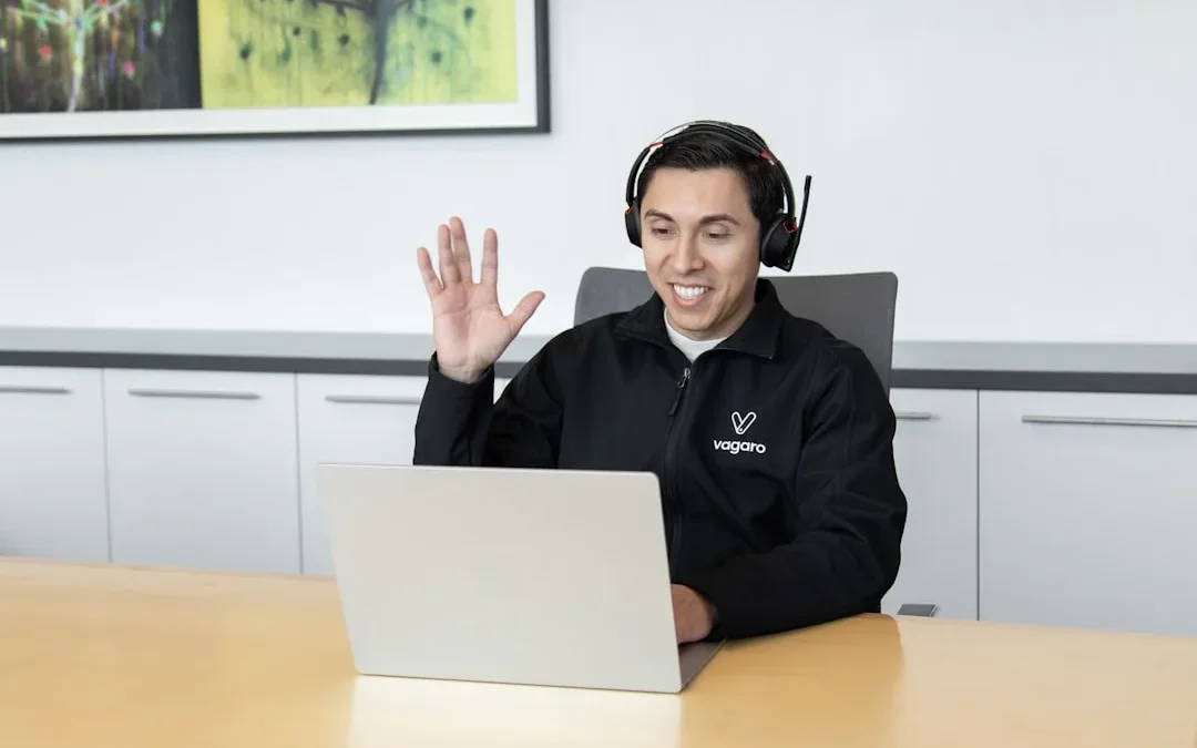 A calm customer support agent typing a helpful reply to a complaint on a laptop