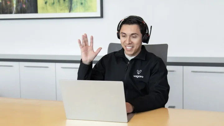 A calm customer support agent typing a helpful reply to a complaint on a laptop