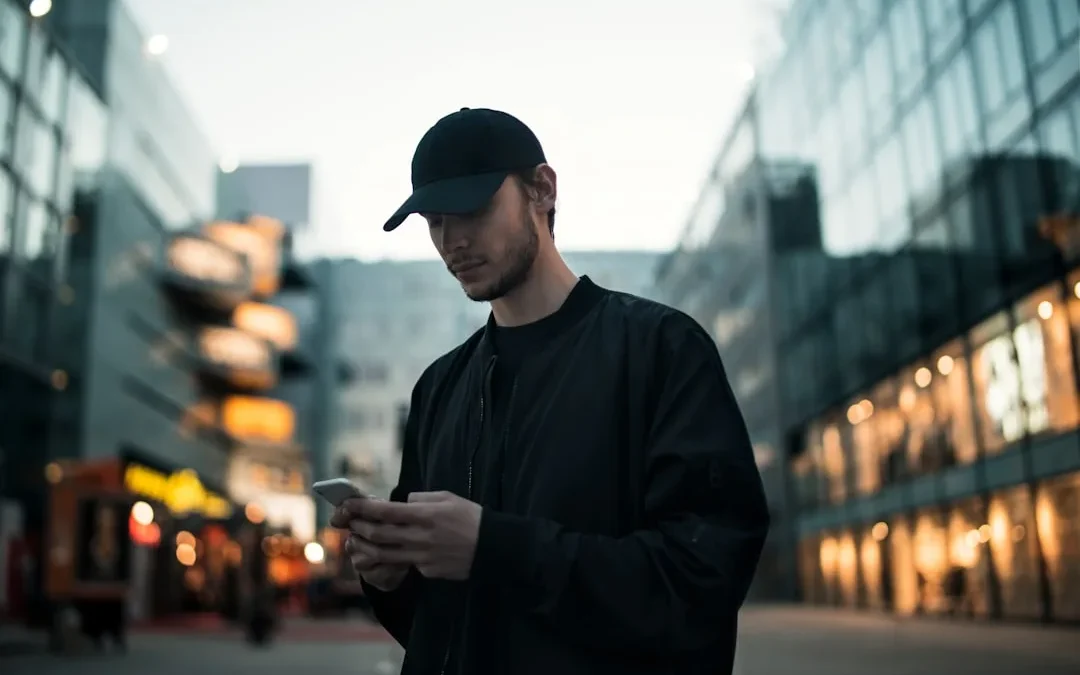 A person looking at their phone with a calm, serious expression after reading an offensive comment
