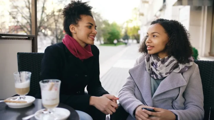 two friends having an honest conversation at a cafe