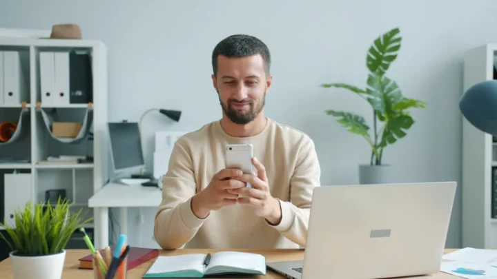 job candidate confirming interview invitation on laptop and phone