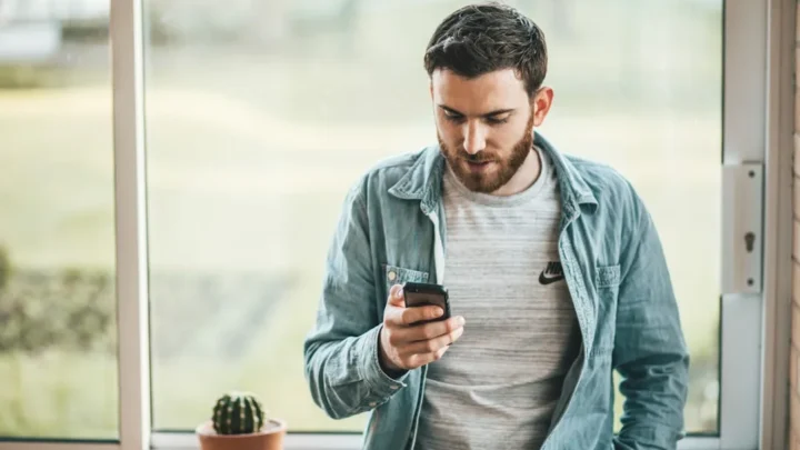 A person sitting calmly and thoughtfully reading a text after some time apart