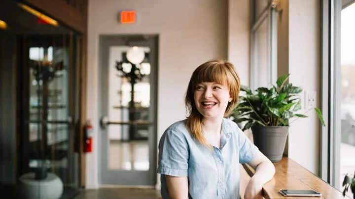 A confident person smiling calmly after being paid a compliment