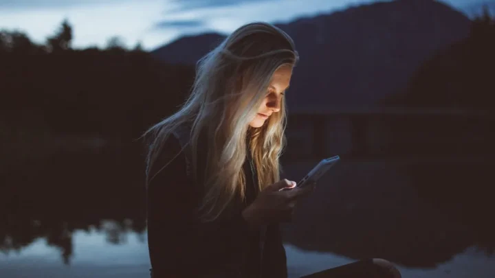 person looking thoughtfully at a read receipt on smartphone