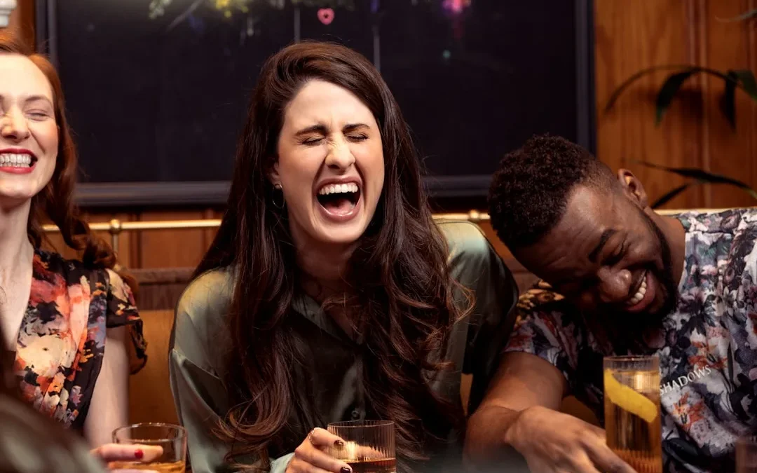 a group of people sitting around a table with drinks