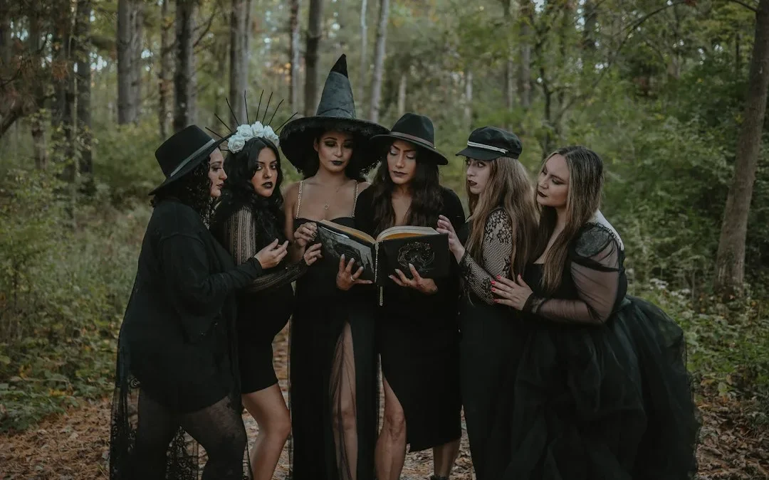a group of women dressed up in witches costumes