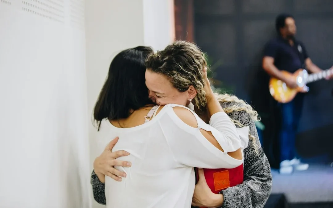 a couple of people that are hugging each other