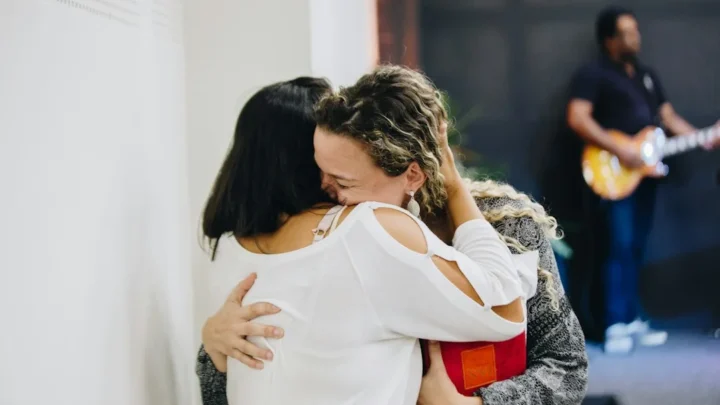 a couple of people that are hugging each other